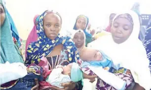  ?? Another groups of mothers pose with their new born babies at Faskari camp. ??