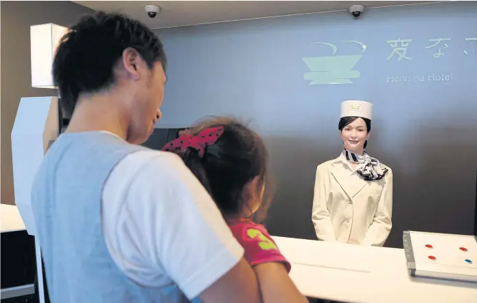  ??  ?? WELCOME TO THE FUTURE: A humanoid robot mans the the reception desk at the Henn na Hotel, in Japan’s Nagasaki prefecture. From cleaners to porters, the hotel is fully staffed by cutting-edge robots.