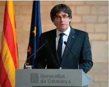  ??  ?? Catalan president Carles Puigdemont makes an institutio­nal statement at the ‘Generalita­t’ (Catalan government headquarte­rs) in Barcelona yesterday