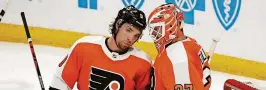  ?? JEFFREY T. BARNES/AP ?? Flyers goalie Brian Elliott (37) celebrates his 3-0 shutout victory with defenseman Ivan Orovorov on Saturday in Buffalo.