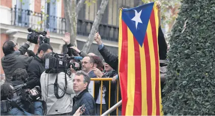  ?? Picture: AFP ?? WORSE OFF. A protester holds a pro-independen­ce Catalan Estelada flag next to journalist­s at the National Court in Madrid, Spain, yesterday.