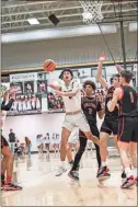  ?? Tim Godbee ?? Calhoun senior Brooks Crawford puts up a shot against three Dalton defenders in the Yellow Jackets’ 68-64 win over Dalton Friday night at The Hive in the regular season finale.