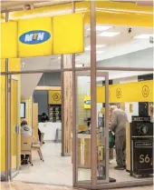  ??  ?? A customer speaks to an employee inside an MTN Group office in Gauteng. MTN yesterday announced an additional management reshuffle.