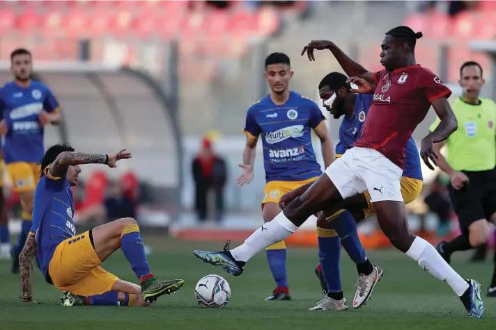  ?? Photo © Domenic Aquilina ?? Emmanuel David Promise Oluwatobi (R) of Valletta vies for the ball with Santa Lucia's Gianmarco Conti (L) during the first half.