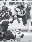  ??  ?? San Diego State fullback Nick Bawden gets tripped up against Army during the first half of the Armed Forces Bowl in Fort Worth, Texas.