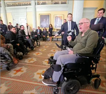  ?? STAFF PHOTO BY STUART CAHILL — BOSTON HERALD ?? Chris Hoeh, of JP, speaks Thursday at a press conference announcing Senate passage of a law establishi­ng new requiremen­ts for wheelchair providers.