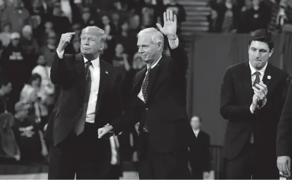  ?? MIKE DE SISTI/MILWAUKEE JOURNAL SENTINEL ?? President Donald Trump invites Sen. Ron Johnson to speak during a campaign rally Jan. 14, 2020, at UW-Milwaukee Panther Arena in Milwaukee. Confidential tax records reveal that Johnson’s last-minute maneuver on Trump’s massive 2017 tax overhaul benefited billionair­es Dick and Liz Uihlein and Diane Hendricks more than almost any others in the country. They are among the senator’s biggest donors.