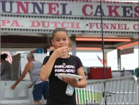  ?? JEFF DOELP — FOR MEDIANEWS GROUP ?? Cristal Ortiz, 10, Temple, eats funnel cake at the 2019Govern­or Mifflin Community Days in Shillingto­n. The 2020Commun­ity Days, scheduled to be held from June 29to July 4, have been canceled due to the coronaviru­s pandemic. The 2021 event will be July 5 to July 10.