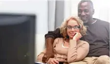  ?? AFP ?? a mature couple sitting together on a sofa watching television. —