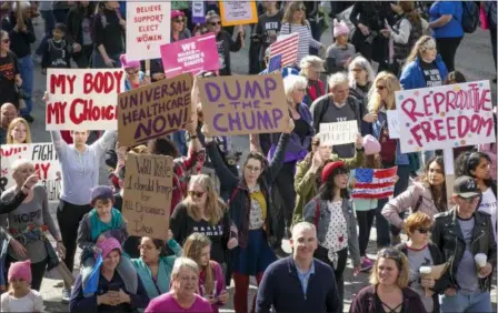  ?? JAY JANNER — AUSTIN AMERICAN-STATESMAN VIA AP ?? In this Saturday file photo, demonstrat­ors hold signs during a Women’s March in Austin, Texas, on the anniversar­y of President Donald Trump’s inaugurati­on. On the anniversar­y of President Donald Trump’s inaugurati­on, people participat­ing in rallies and...