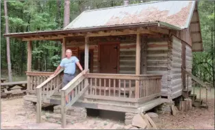  ?? SUBMITTED ?? Charles Riddle of Wichita, Kansas, visited the cabin of his grandmothe­r, folk singer Almeda Riddle. His great-grandfathe­r, J.L. James, built the cabin. Charles owns his great-grandfathe­r’s ax, probably the one used to cut and shape the logs in this cabin, now reconstruc­ted and moved to the South Fork Nature Center in Choctaw.