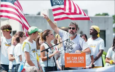  ?? GETTY IMAGES ?? Manuel Oliver and his wife Patricia Oliver, parents of Parkland shooting victim Joaquin Oliver, join a rally at the end of an 80-kilometer walk against gun violence in front of the Smith and Wesson Firearms factory in Springfiel­d, Massachuse­tts, on Sunday.