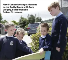  ??  ?? Max O’Connor looking at his name on the Buddy Bench, with Zach Gregory, Sam Behan and Callum Fitzsimons.