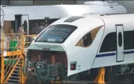  ?? ZHU XINGXIN / CHINA DAILY ?? Workers assemble a train in a factory of CRRC Changchun Railway Vehicles Co in Changchun this month.