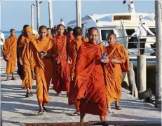  ?? — AP ?? Still missing: Buddhist monks visiting a pier of Koh Rong island where Bambridge went missing.