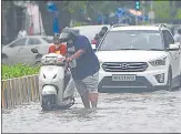  ??  ?? A biker tries to start the vehicle on a waterlogge­d road in Andheri on Wednesday.