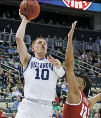  ?? GENE J. PUSKAR — THE ASSOCIATED PRESS ?? Villanova guard Donte DiVincenzo, right, lofts a shot over Alabama’s Dazon Ingram during the first half of a second-round NCAA tournament game Saturday. Eighteen first-half points from “The Big Ragu” kept Villanova afloat before the Wildcats pulled...