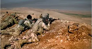  ?? —AFP ?? Members of the Iraqi army hold a position on the outskirts of Mosul. The eastern side of the city has been liberated, and efforts are now on to free the remaining areas from the clutches of Daesh.