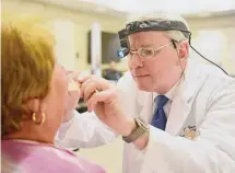  ?? Tyler Sizemore/Hearst Connecticu­t Media ?? Dr. Richard Brauer performs a free head and neck cancer screening at Greenwich Hospital in Greenwich, Conn. After a recent federal court ruling, will free scans go away?