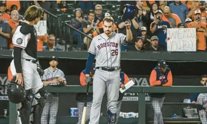  ?? KEVIN RICHARDSON/BALTIMORE SUN ?? Houston Astros first baseman Trey Mancini tips his cap while receiving a standing ovation from the crowd at Camden Yards. Thursday marked the former longtime Oriole’s first game in Baltimore since he was traded Aug. 1.