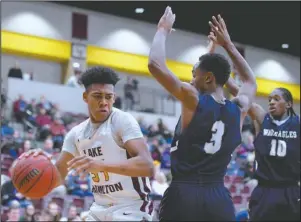  ?? The Sentinel-Record/Grace Brown ?? POST UP: Lake Hamilton senior forward Kanaan Williams (34) pushes into the lane Friday against J.A. Fair senior Braylon Haynie (3) during the Wolves’ 57-43 home victory at Wolf Arena in Pearcy.