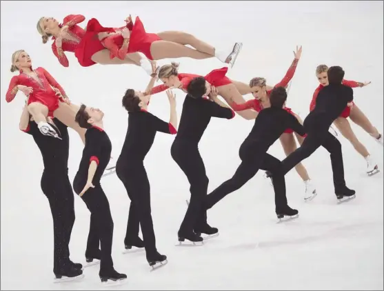  ?? The Associated Press ?? In this multiple exposure image, Kirsten Moore-Towers and Michael Marinaro of Canada perform in the pairs figure skating short program at the 2018 Winter Olympics in Gangneung, South Korea, on Wednesday. They were 13th after the short program and...