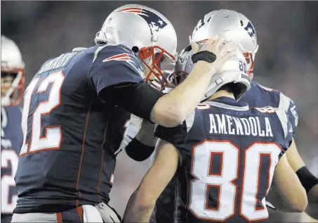  ?? Charles Krupa ?? New England Patriots quarterbac­k Tom Brady celebrates his touchdown pass to wide receiver Danny Amendola on Sunday. The Associated Press