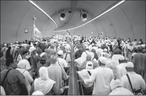  ?? AP/MOSA’AB ELSHAMY ?? Muslims walk through a tunnel in Mina, Saudi Arabia, on their way to cast stones at Jamarat pillars, a ritual that symbolizes the stoning of Satan, during the annual hajj pilgrimage.