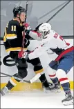 ?? STUART CAHILL / BOSTON HERALD ?? Capitals defenseman Justin Schultz hits Bruins center Trent Frederic on Friday night.