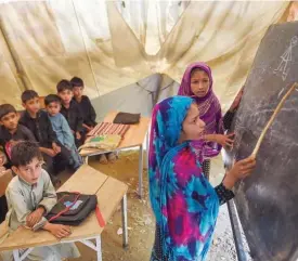  ??  ?? Children attend a class at a tent school in Tanjai Cheena, a village in Swat Valley.