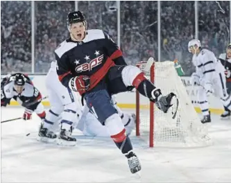  ?? PATRICK SMITH GETTY IMAGES ?? Capitals’ John Carlson celebrates his goal against the Maple Leafs in the second period at Navy-Marine Corps Memorial Stadium in Annapolis, Md., on Saturday night. Washington won going away.