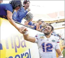  ?? BRIAN BLANCO / GETTY IMAGES ?? QB Austin Appleby celebrates with Florida fans after winning despite a shaky start, including intercepti­ons on the first two possession­s.