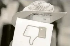  ?? AFP ?? ▪ A protester during a demonstrat­ion outside Facebook’s headquarte­rs in the wake of Cambridge Analytica's unauthoris­ed access to around 87 million Facebook users' data