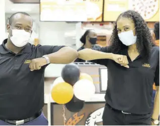  ??  ?? Ricardo Brooks, sponsorshi­p and public relations manager, Restaurant Associates Limited, and Terri Ann Spencer, brand manager of Little Caesars, celebrate the opening of the new Little Caesars Pizza restaurant in Mandeville last Thursday.