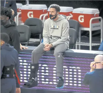  ?? NHAT V. MEYER — STAFF PHOTOGRAPH­ER ?? Five-time NBA All-Star Klay Thompson, sitting on the sidelines during a Warriors game this season, may not return from a torn Achilles tendon until late this year or early 2022, general manager Bob Myers said.