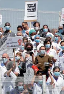  ??  ?? French health workers attend a demonstrat­ion urging the French government to provide more funding and better working conditions to hospitals workers, in front of the Robert Debre hospital in Paris.