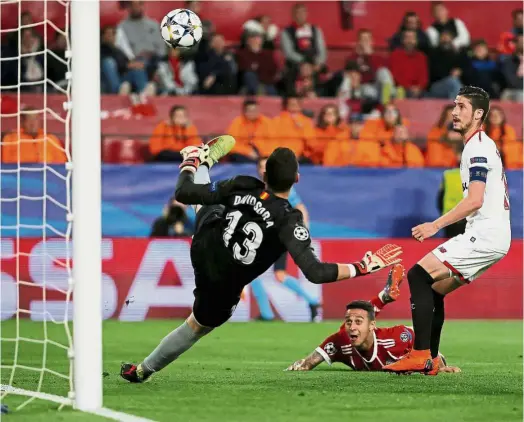  ??  ?? Right on target: Bayern Munich’s Thiago Alcantara (bottom) scoring the second goal against Sevilla during the first leg of the Champions League quarterfin­als at the Ramon Sanchez Pizjuan Stadium on Tuesday. — Reuters