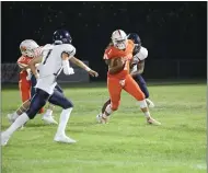  ??  ?? Woodland High School running back James Thompson rushes for a slight gain during the third quarter of the Wolves game against River City Friday night.