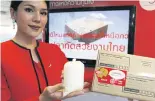  ??  ?? A presenter shows a bag containing Siamese fighting fish for delivery via Thailand Post.