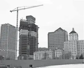  ?? MIKE DE SISTI / MILWAUKEE JOURNAL SENTINEL ?? Cudahy Tower Apartments, far right, has long been part of a downtown lakefront skyline that includes Northweste­rn Mutual’s office tower, shown under constructi­on in 2016.