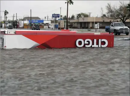  ?? PHOTO/ERIC GAY ?? The roof of a gas station sits in flood waters in the wake of Hurricane Harvey, Saturday, in Aransas Pass, Texas. AP