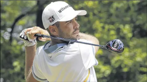  ?? STEVE HELBER / AP ?? Troy Merritt fired a 10-under 61 to set a Quicken Loans National tournament record and take his second third-round lead of the season, a tie with Kevin Chappell at 14 under. Tourney host Tiger Woods slid down the leaderboar­d.