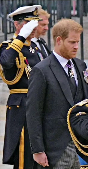  ?? ?? Paying their respects: Prince Harry and Prince Andrew, both wearing morning suits, appear lost in thought as King Charles and Princess Anne salute in their Royal Navy uniforms at Westminste­r Abbey