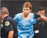  ?? AP PHOTO ?? In this Monday photo, Travis Reinking, suspected of killing four people in a late-night shooting at a Waffle House restaurant, is escorted into the Hill Detention Center in Nashville, Tenn., Monday.