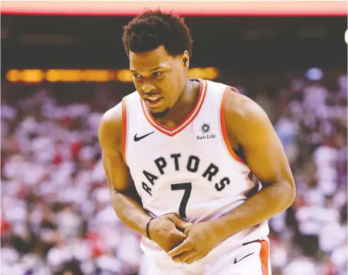  ?? FRANK GUNN / THE CANADIAN PRESS ?? Raptors guard Kyle Lowry walks off the court after hurting his thumb in Game 7 of the NBA Eastern Conference semifinal against Philadelph­ia.
