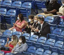  ?? JOE SONGER / BIRMINGHAM NEWS ?? Friends and family watch Spain Park High’s graduation Wednesday in Hoover, Alabama. Everyone attending had to wear a mask as a precaution against coronaviru­s.