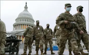  ?? JACQUELYN MARTIN — THE ASSOCIATED PRESS ?? Members of the National Guard work inside a secured area of the U.S. Capitol complex, on Saturday, Jan. 16, 2021, in Washington, as security is increased ahead of the inaugurati­on of President-elect Joe Biden and Vice President-elect Kamala Harris.