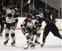  ?? Dave Phillips/For Hearst Connecticu­t Media ?? North Haven’s Owen Quick skates past Logan Bertrand as he heads towards the goal. Will Sullivan of North Haven looks on at left.