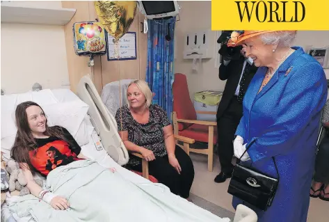  ?? PETER BYRNE / POOL VIA AP ?? Queen Elizabeth speaks to Millie Robson, 15, and her mother, Marie, during a visit Thursday by the British monarch to the Royal Manchester Children’s Hospital to meet victims of Monday’s terror attack in Manchester, and to thank members of staff who...