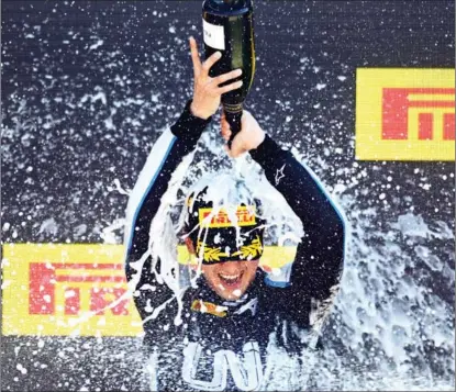  ?? MICHAEL REGAN / GETTY IMAGES ?? Zhou of team UNI-Virtuosi Racing celebrates his win in the Silverston­e feature race of the Formula 2 Championsh­ip on July 18 in Northampto­n, England.